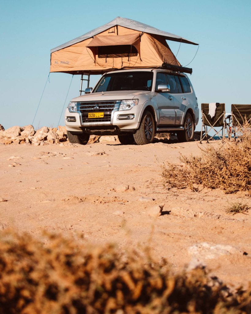 White car with roof tent